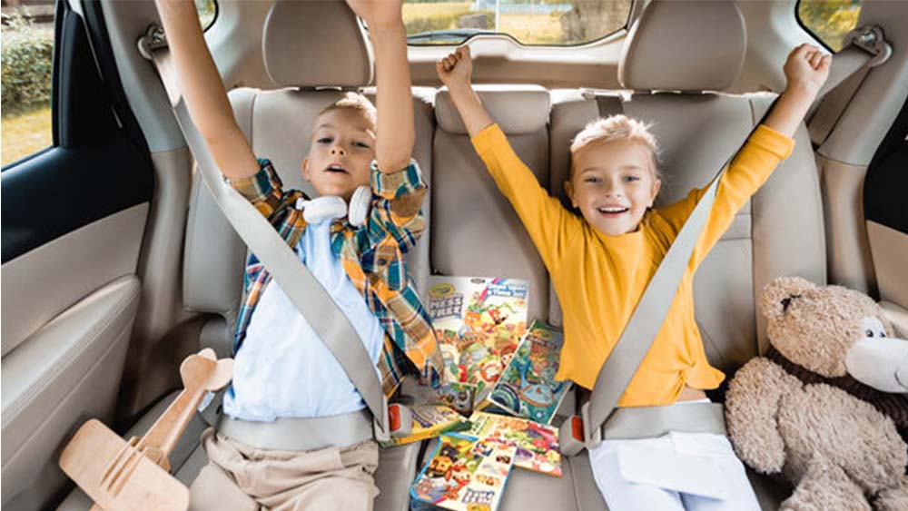 Kids in a car ready to travel.